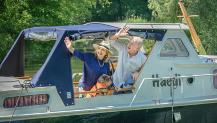 Janny en André in de boot met Nhaan voor Denkend aan Holland
