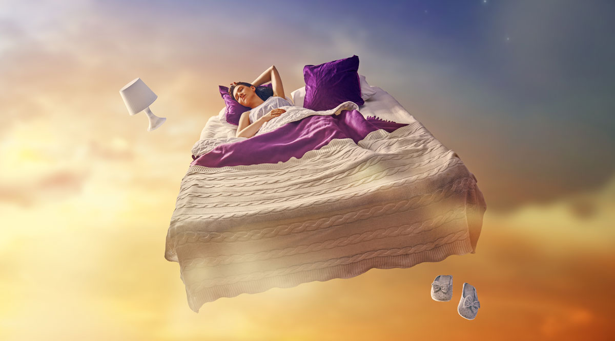 Een vrouw ligt in bed - dat in de lucht zweeft - te dromen.