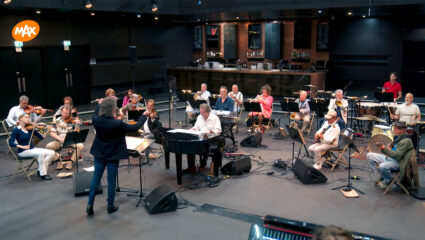 De 20 orkestleden van Het MAX Orkest tijdens een repetitie.