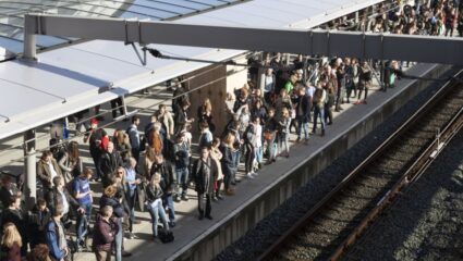 Mensen staan op het perron op de trein te wachten.