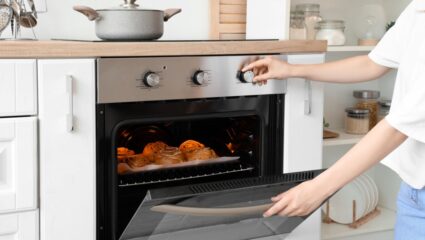 Keuken met broodje in de oven en overdeur open