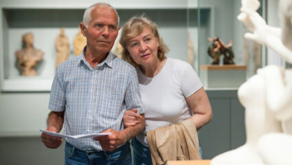 Een man en een vrouw zoeken verkoeling op in een museum