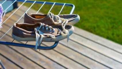 Twee schoenen die aan het drogen zijn op een wasrek.