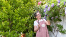 Een vrouw gaat een blauweregen snoeien in de zomer
